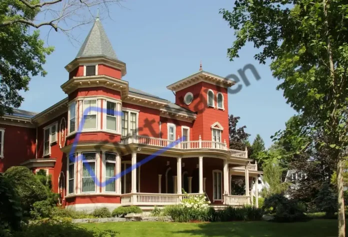 Stephen King's house in Bangor, Maine, showcasing its distinctive red color and wrought iron fence with bats and spiders.